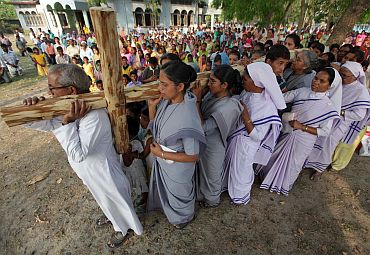 Christians carry a wooden cross outside a church on the occasion of Good Friday at Bagdogra on the outskirts of Siliguri in West Bangal on April 2, 2010.