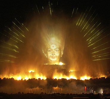 An image of a Hindu god is projected as part of the Sat-Chit-Anand water show with fires and fountains at Akshardham temple in Gandhinagar, Gujarat
