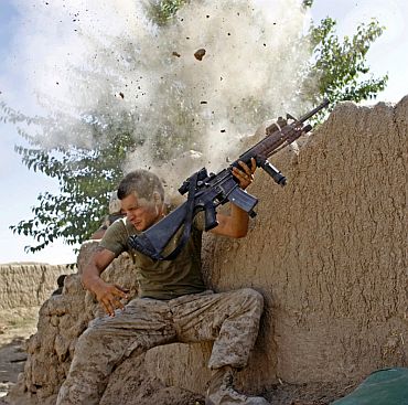 A US Army soldier barely misses being hit by a bullet during combat in Afghanistan