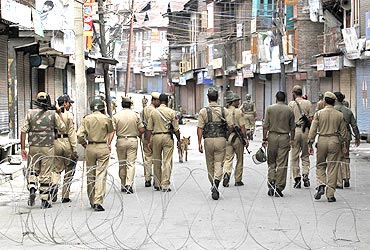 Police patrol a curfew-bound locality in Srinagar