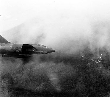 A US Air Force F-100 Super Sabre fires a salvo of rockets at a jungle target in Vietnam, May 1967