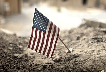 An American flag is placed in a dirt-filled barrier outside the headquarters of 3rd Platoon near Kandahar
