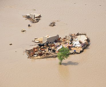 A family marooned by flood waters is seen from an Army helicopter in the Rajanpur district of Pakistan's Punjab province
