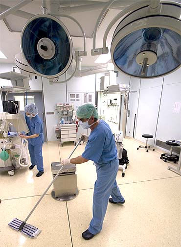 Staff disinfect the operating theatre of a Berlin hospital after an procedure on a patient with MRSA