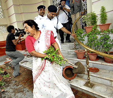 Politician Jyoti Devi breaks flower pots after she was expelled from the Bihar Legislative Assembly