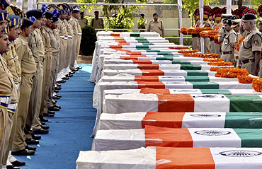 CRPF personnel pay their last respects near the coffins of policemen who died in a Naxal attack