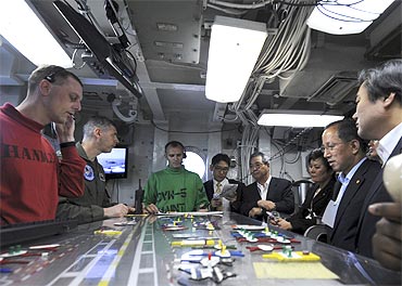 US officals speak to South Korean Defense Minister Tae Young Kim (2nd R) and other ministers aboard USS George Washington in July, 2010