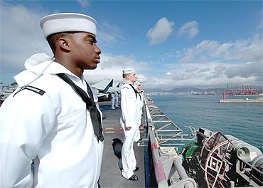 American sailors man the rails of the USS George Washington aircraft carrier as the ship arrives in Busan on July 21, 2010