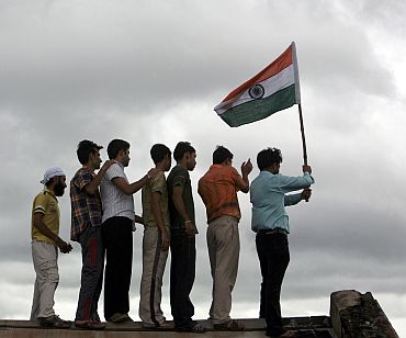 A man holds the Indian flag during independence day celebrations in Jammu