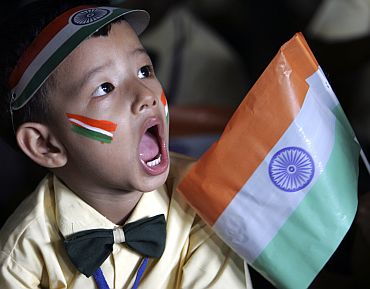 A boy attends Independence Day celebrations at a school in a slum area in Siliguri