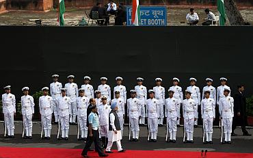 India's Prime Minister Manmohan Singh inspects a guard of honour at the Red Fort
