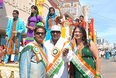 Dr. Sanjay Gupta President of Indo-US council , Grand Marshal Shivamani and Mrs Gupta at the Atlantic City India Day function