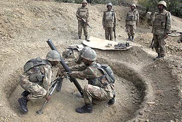-Pakistani soldiers prepare to fire mortars towards Taliban militant positions in South Waziristan
