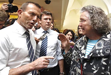 Australian Opposition leader Tony Abbott speaks to a shopper at a Melbourne shopping centre
