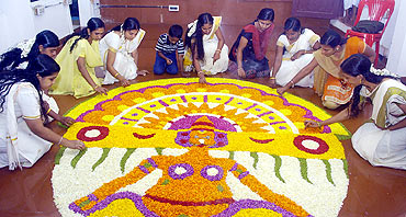 Women decorate with flowers to welcome King Mahabali's revisit during Onam celebrations in Thiruvananthapuram