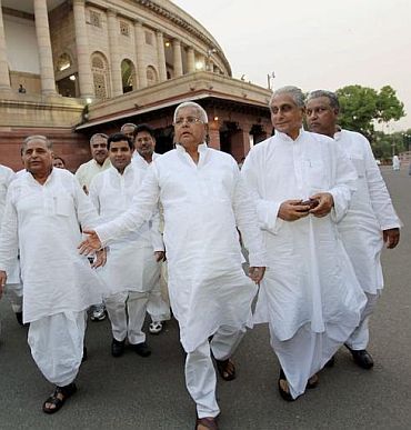 RJD chief Lalu Prasad Yadav, who held a mock Parliament over the pay issue, leaves the premises along with other MPs