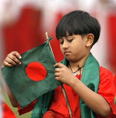 A Bangladeshi kid waves the national flag