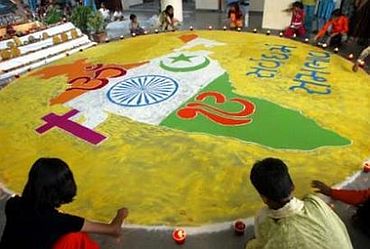 School kids draw a map of India with symbols of Hinduism, Islam, Christianity and Sikhism in Gujarat