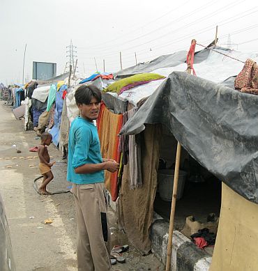 Babu Rao, a slum dweller, shows his current abode