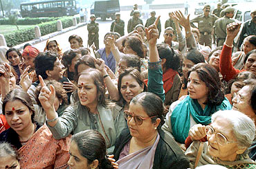 Women activists shout slogans during a protest outside Parliament demanding introduction of the women's reservation bill