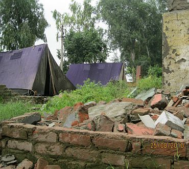 Police camps at the bulldozed slum location