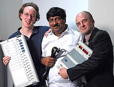 EVM report authors (left to right) J Alex Halderman, Hari K Prasad, and Rop Gonggrijp holding the EVM that they hacked into