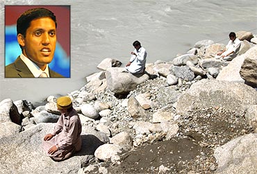 Three men pray by the banks of the Swat River and (inset) Rajiv Shah