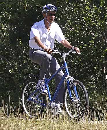 US President Barack Obama rides along a bike path in Martha's Vineyard