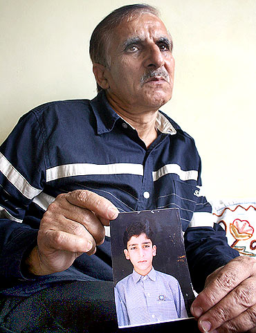 Mohammed Ashraf Mattoo with his son Tufail's photograph
