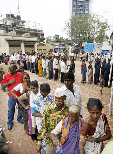 People queue to cast their votes during the Maharashtra state elections in Mumbai in October 2009