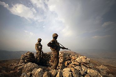 Pakistani soldiers keep guard on top of Kund mountain near Kotkai village in South Waziristan