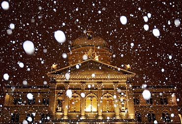 Snow falls in front of Switzerland's federal parliament building in Bern