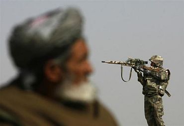 A French sniper looks through his rifle's scope while keeping watch over Qarabagh district, north of Kabul