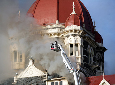 Firefighters try to douse a fire at the Taj Mahal Hotel in Mumbai during the 26/11 terror attacks