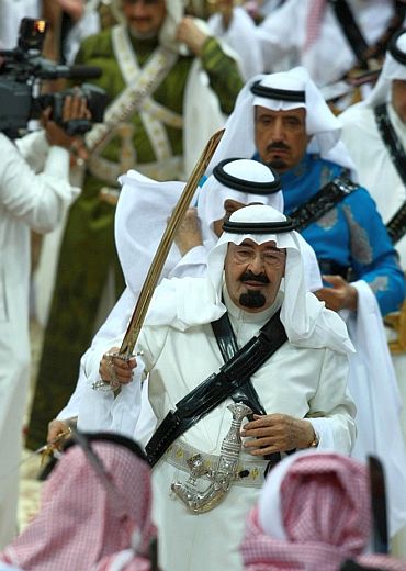 File photo shows King Abdullah taking part in a religious festival in Riyadh
