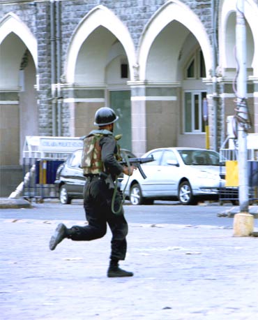 A NSG commando takes position near the Taj Hotel during the 26/11 terror attacks in Mumbai