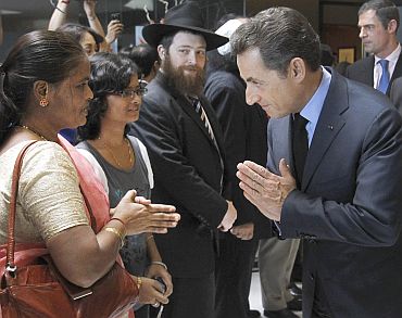 France's President Nicolas Sarkozy greets relatives of 26/11 victims