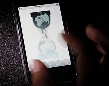 A person checks the WikiLeaks site on his mobile phone