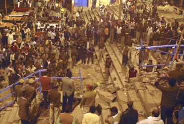 Onlookers at the site of the blast in Varanasi on December 7, 2010