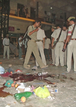 Police inspect the site of a bomb blast in Varanasi on March 7, 2006