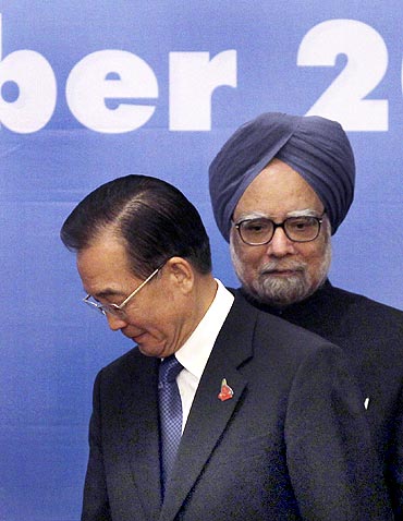 China's Premier Jiabao walks past PM Dr Singh during the 5th East Asia Summit in Hanoi