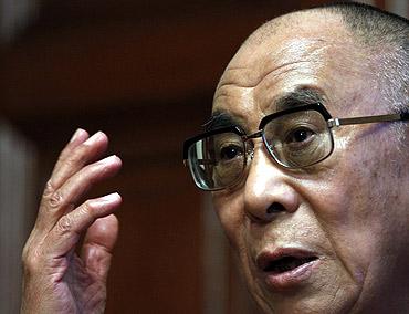 Tibetan spiritual leader, the Dalai Lama, gestures during a news conference in Budapest