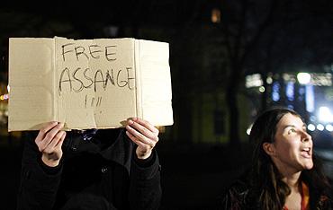 A protestor holds a banner in support of WikiLeaks founder Julian Assange during a flash mob demonstration, organised through the internet, in front of the British Embassy in Sofia