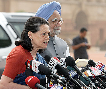 Congress chief Sonia Gandhi addresses the media next to Prime Minister Manmohan Singh in New Delhi