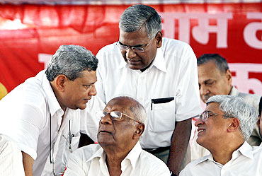 Senior Left leaders Sitaram Yechury (L), A B Bardhan, D Raja (C standing) and Prakash Karat (R) discuss during a rally in New Delhi