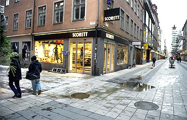People pass a bomb blast site in central Stockholm