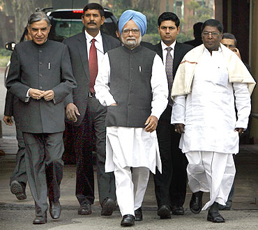 PM Dr Singh walks out of the Parliament with Parliamentary Affairs Minister Pawan Kumar Bansal (right) and Junior Minister V Narayanswamy