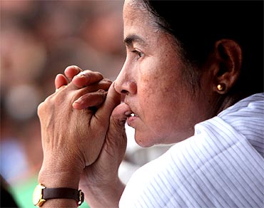 Trinamool Congress chief Mamata Banerjee watches her activists before she speaks during a protest rally in Singur, West Bengal