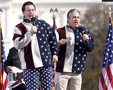 Comedians Jon Stewart and Stephen Colbert sing during the 'Rally to Restore Sanity and/or Fear'