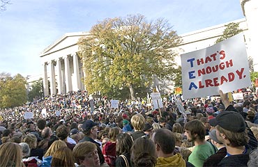 A person with a sign referring to the Tea Party movement stands amidst thousands in Washington